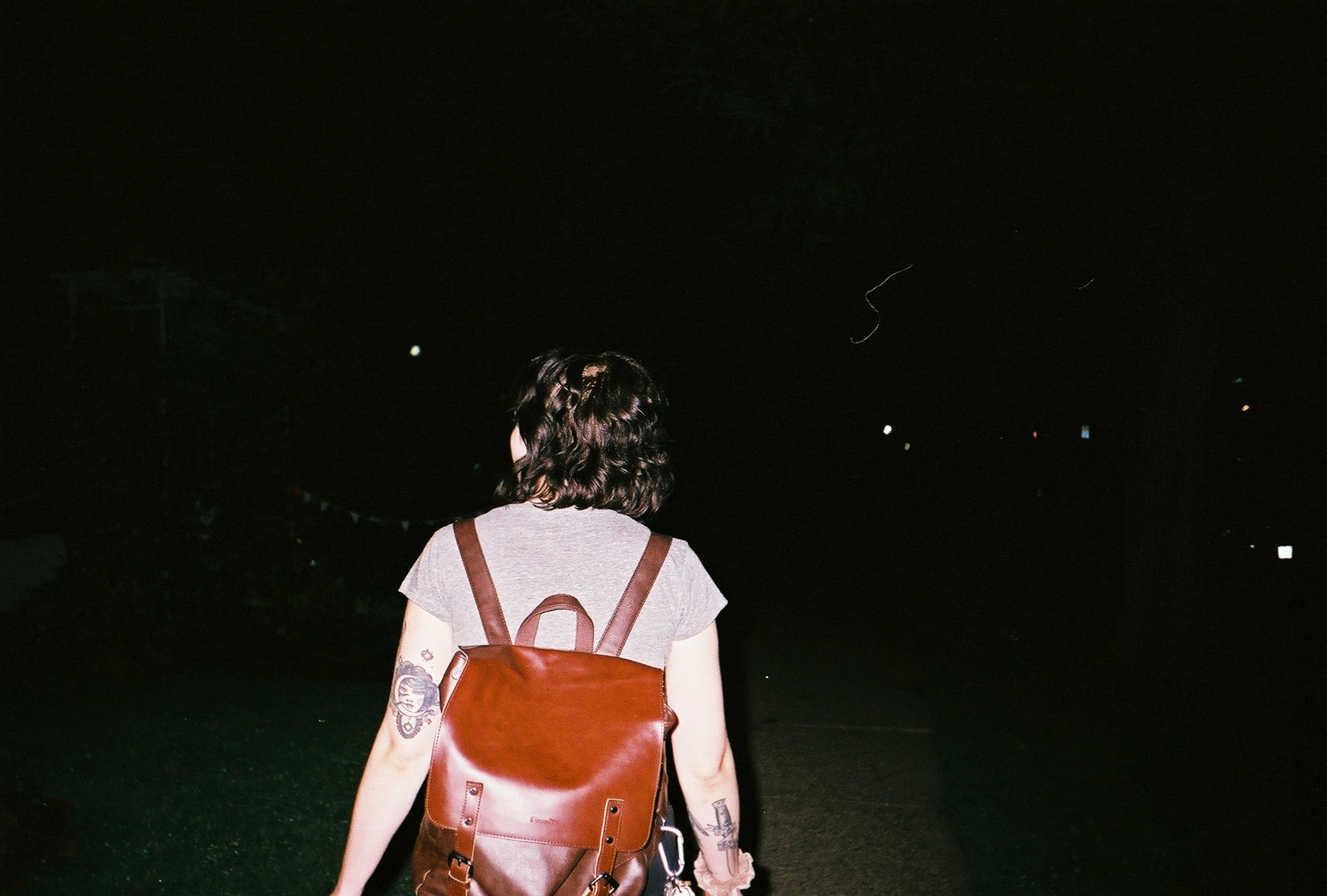 College girl with backpack at night