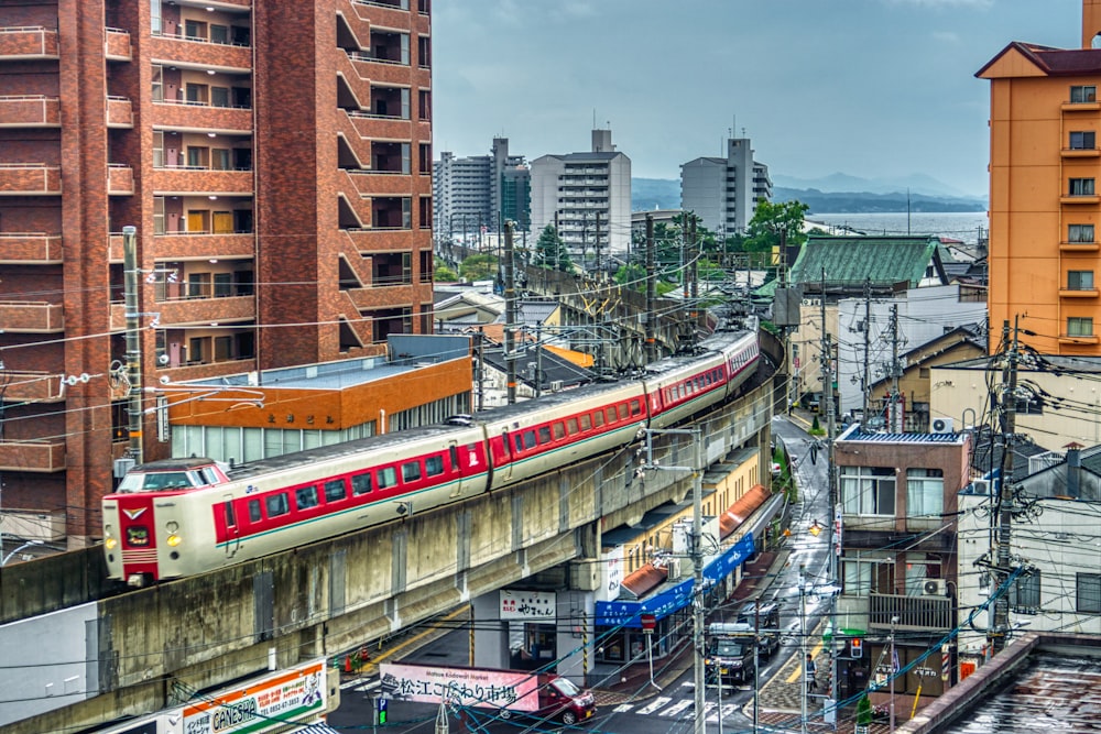 train on track by building during daytime