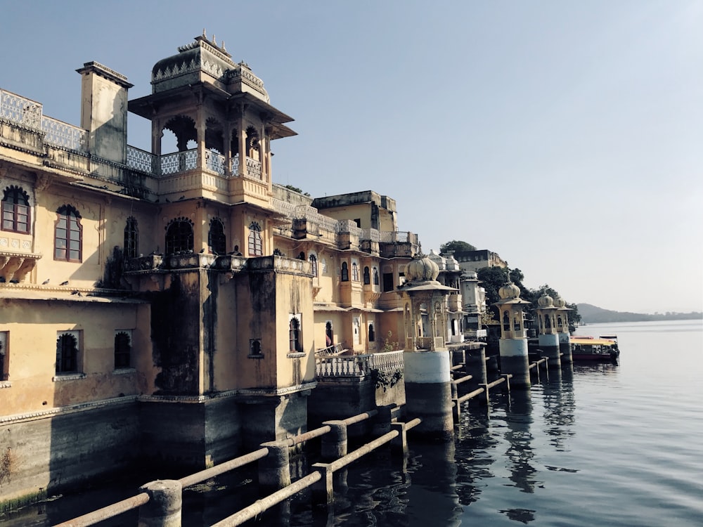 yellow painted buildings near body of water view during daytime