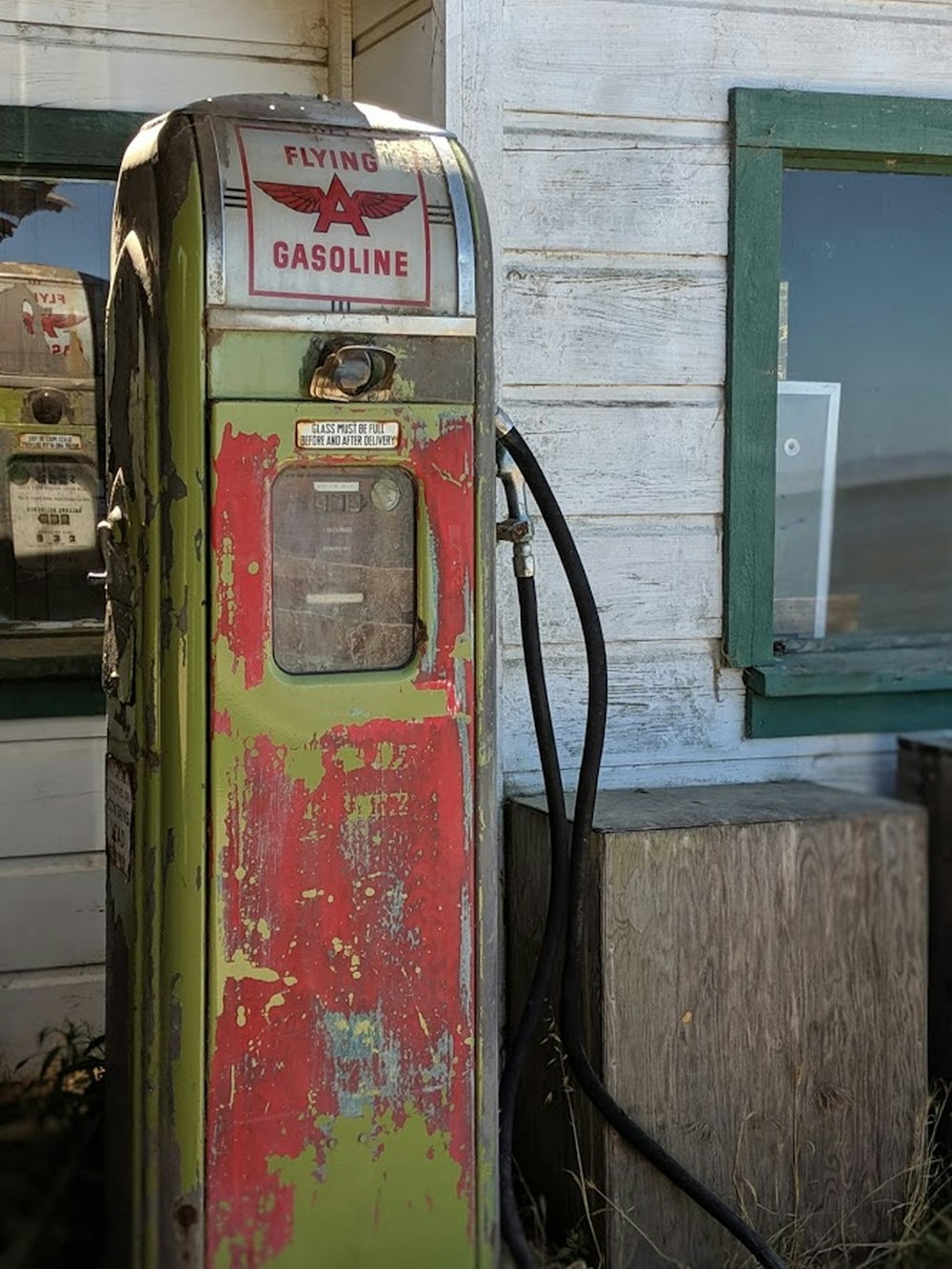 Flying Gasoline has pump by wooden housde