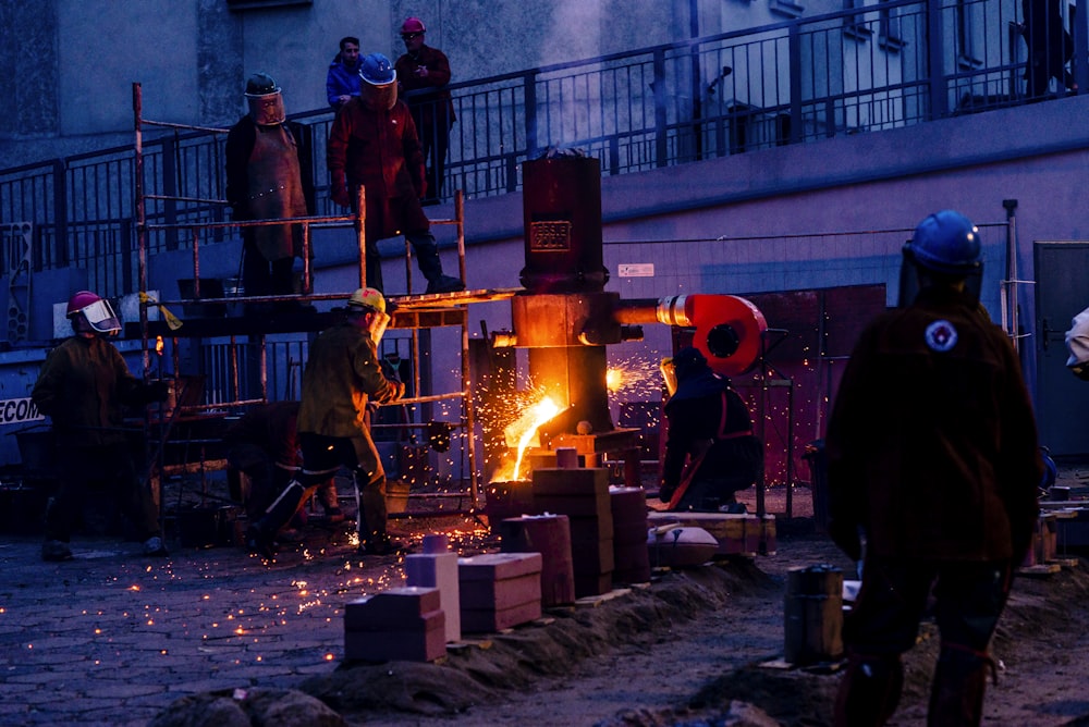 a group of people standing around a fire