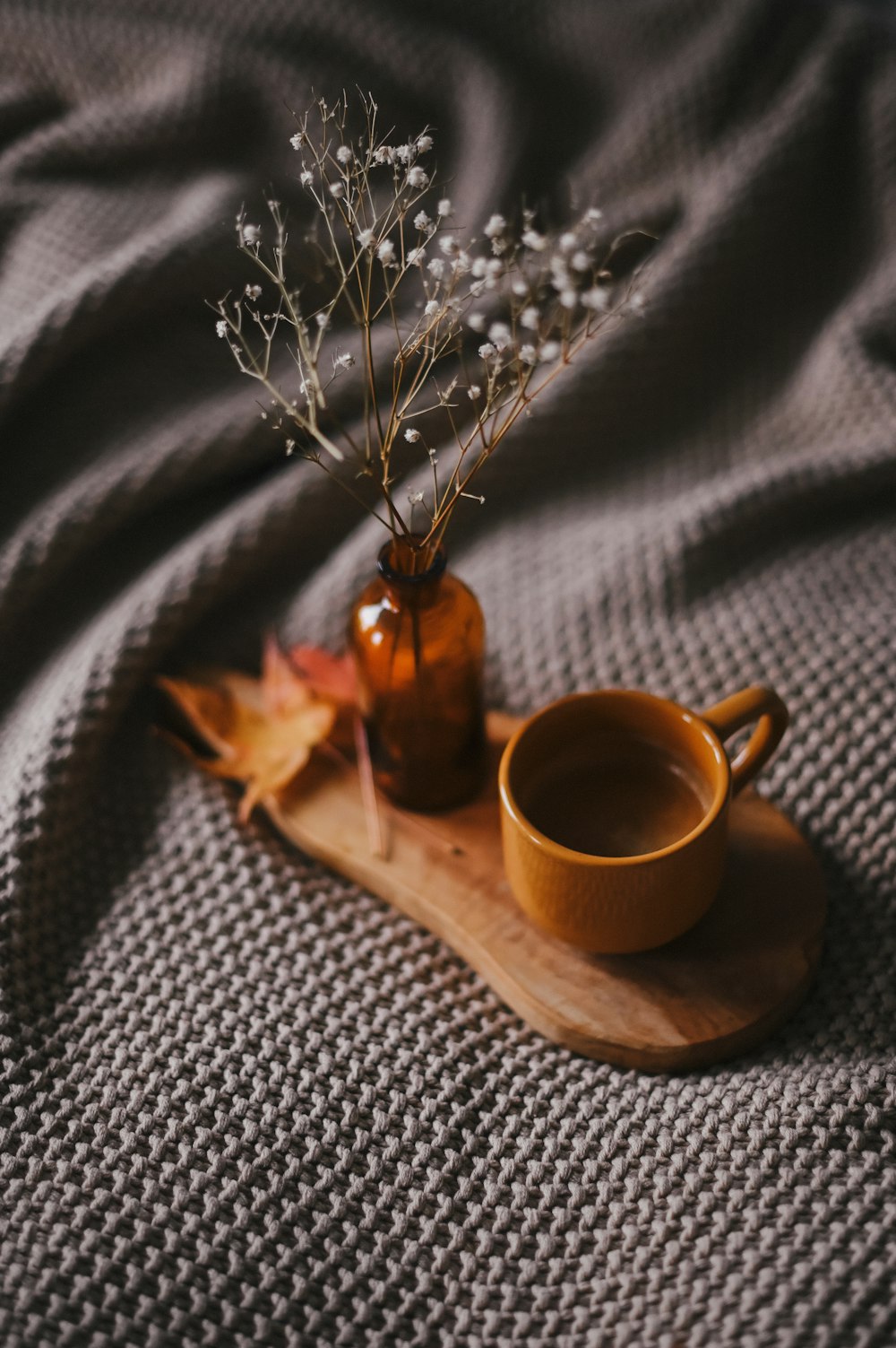 brown ceramic mug on wooden tray