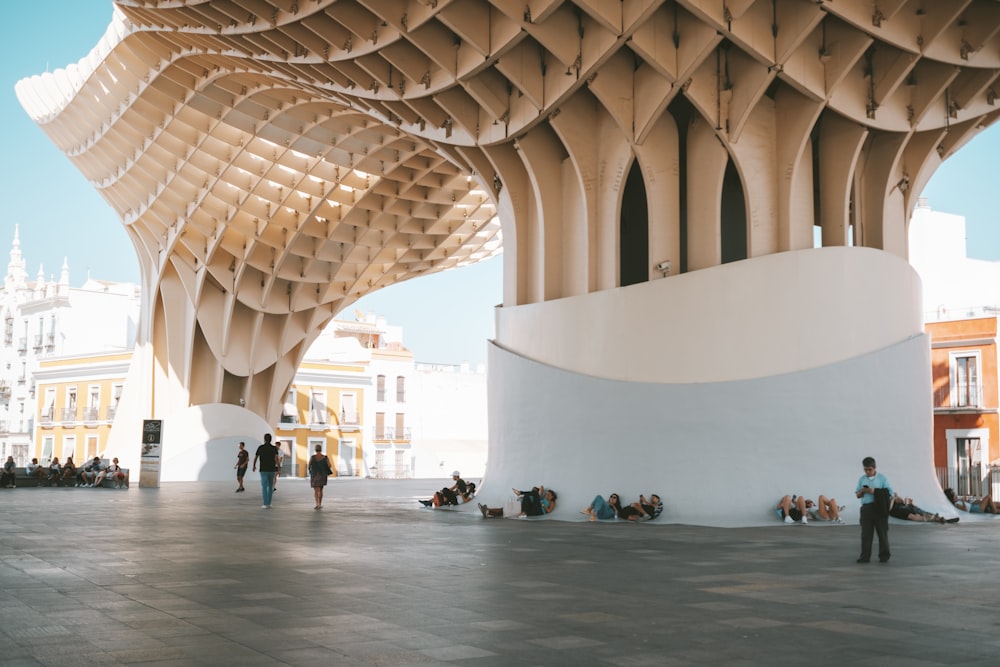 people under brown and white building