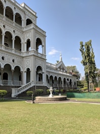 white mansion house with water fountain