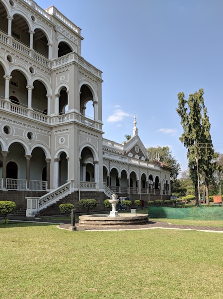 white mansion house with water fountain