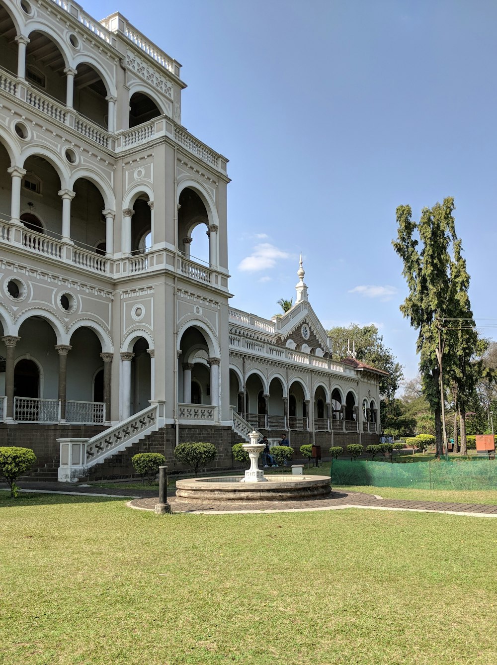 white mansion house with water fountain