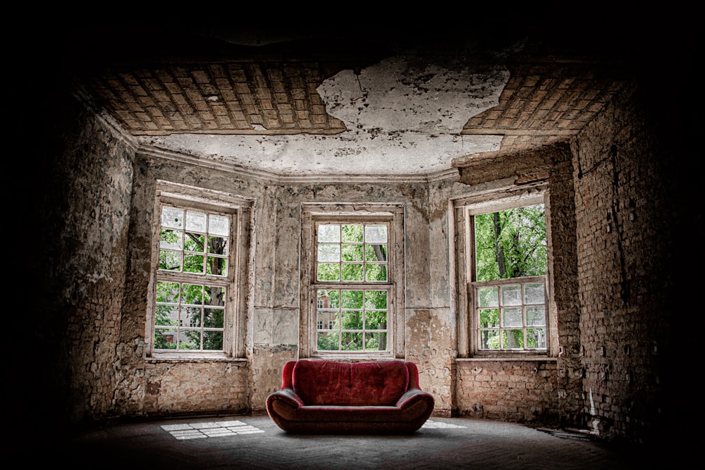 red fabric sofa near the window