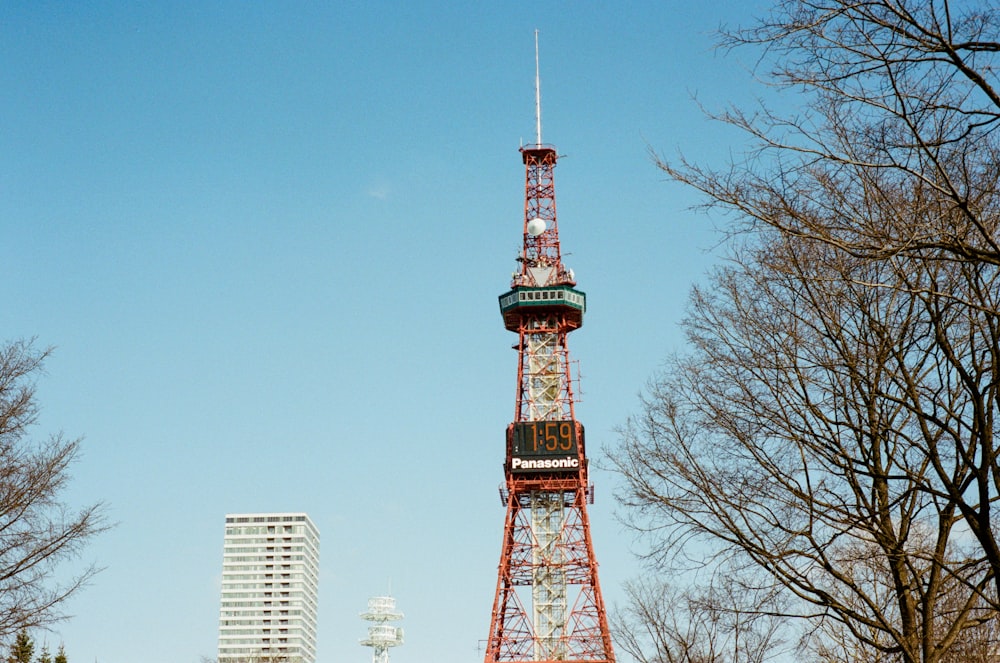 orange and green tower satellite near buildings during daytime