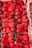 A collection of vibrant red strawberries neatly arranged in cartons. The strawberries are fresh, large, and shiny with green stems. The image highlights the variety and abundance of the fruit.