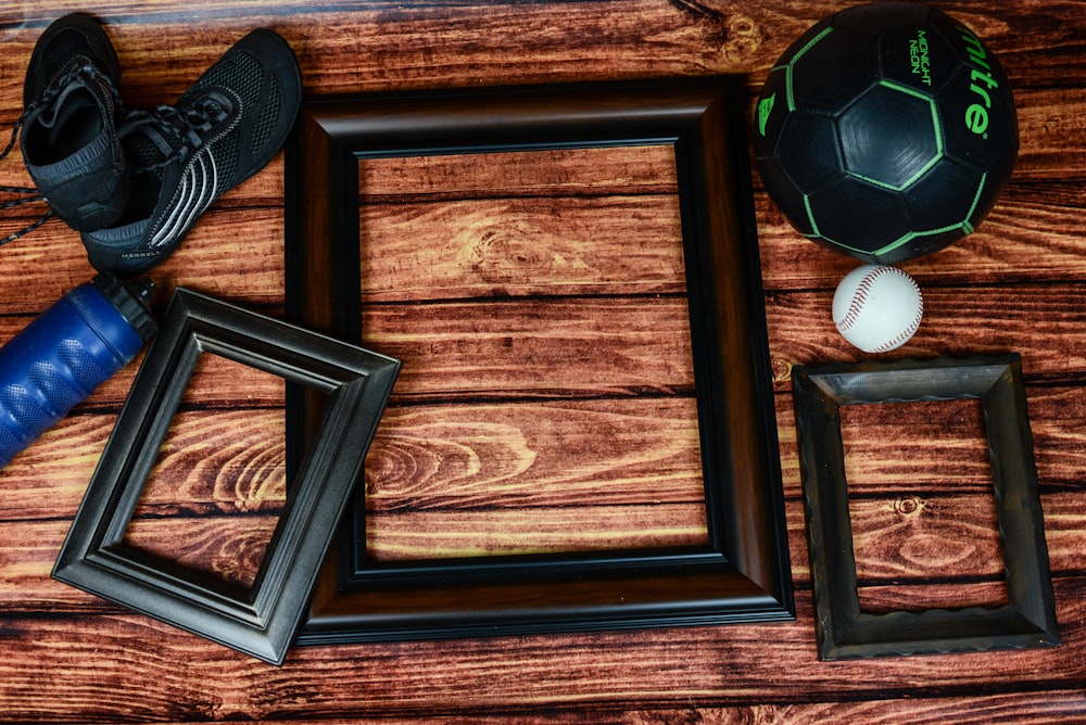 three rectangular black and brown photo frames on brown surface