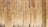Vertical wooden planks aligned closely together create a textured pattern with varying shades of natural wood grain. The surface appears weathered, with some planks showing darker areas due to age or exposure.