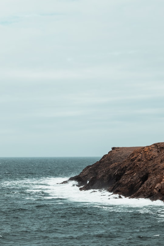 ocean wave splashing on rock during daytime in Groix France