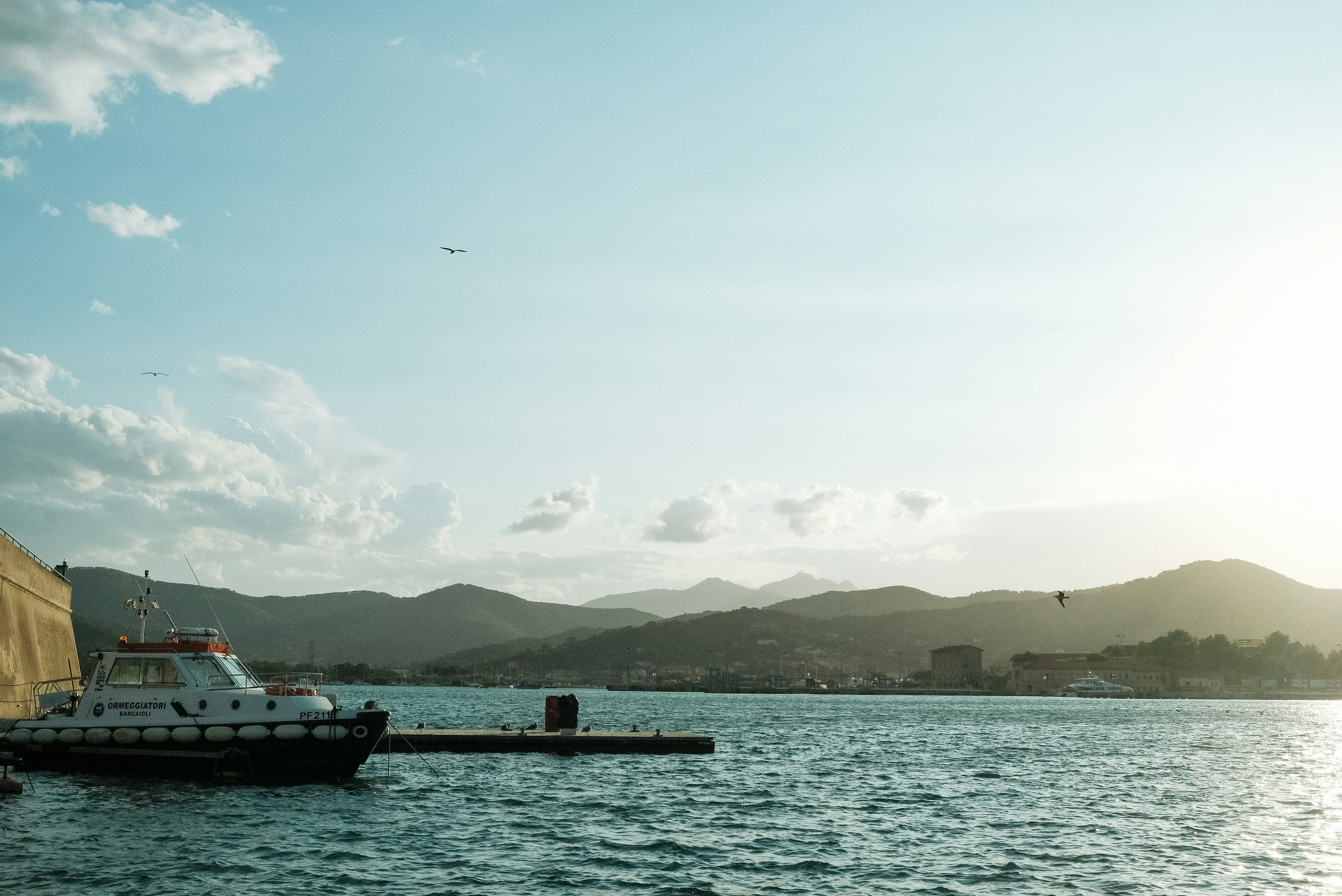white boat on body of water during daytime