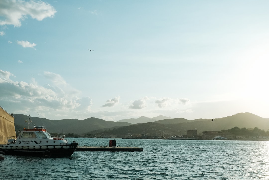 white boat on body of water during daytime