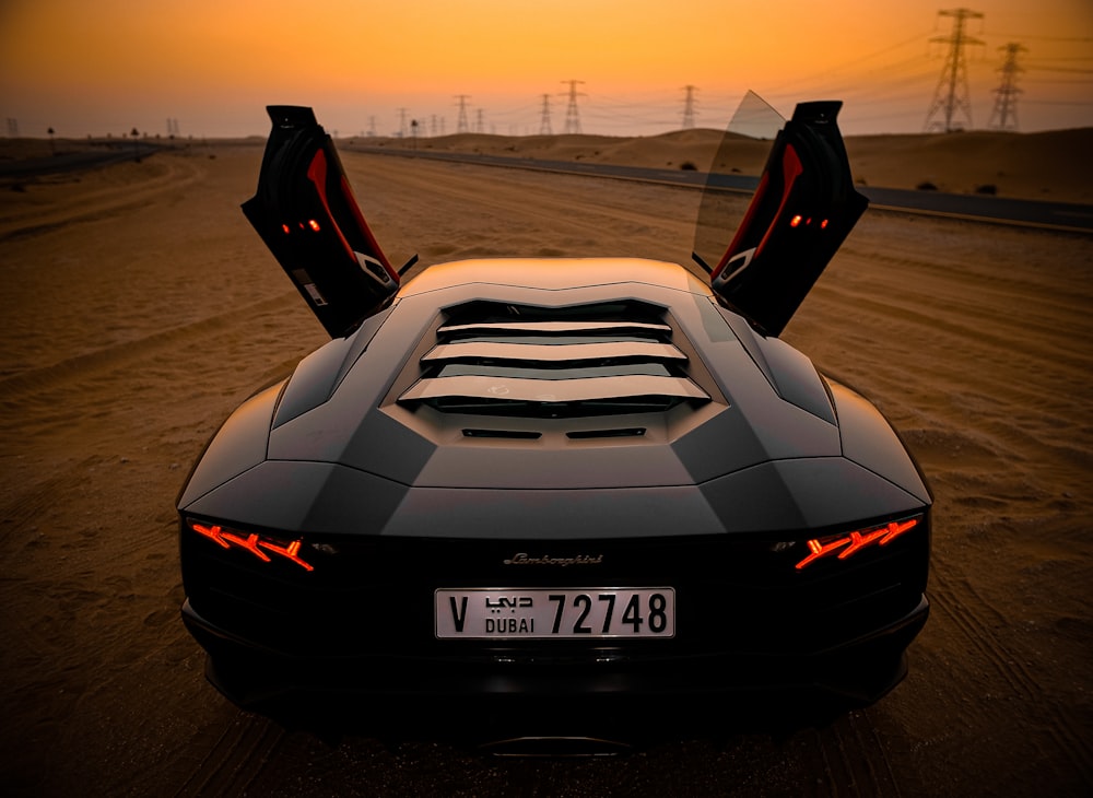 closeup photo of gray coupe on desert