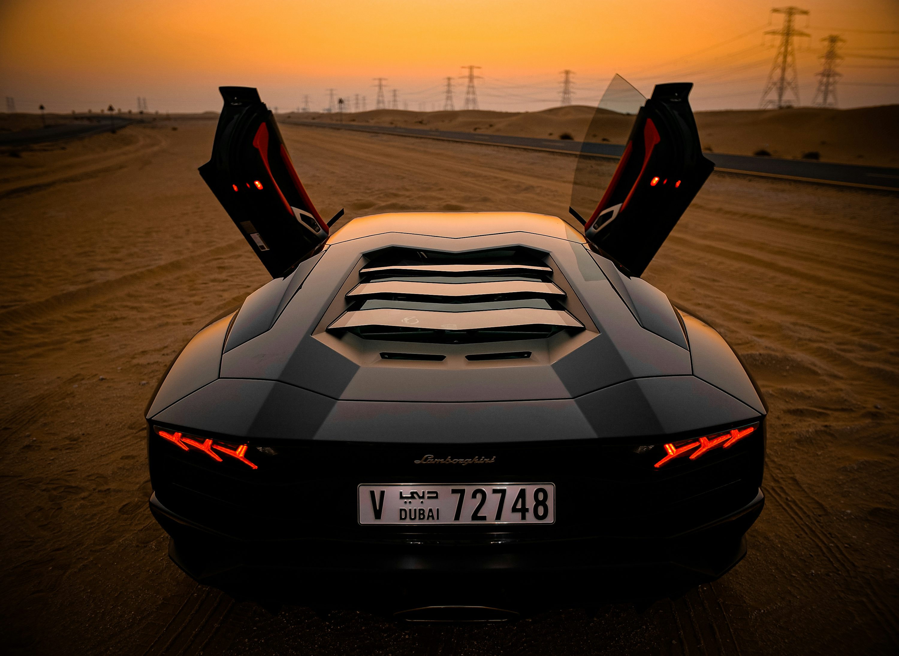 closeup photo of gray coupe on desert