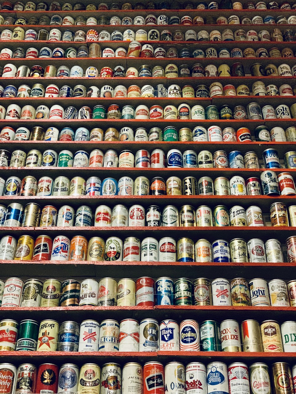 assorted-brand beverage can lot on rack