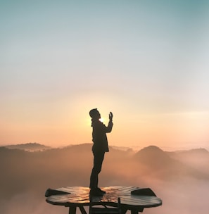 silhouette of praying man