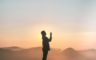 silhouette of praying man
