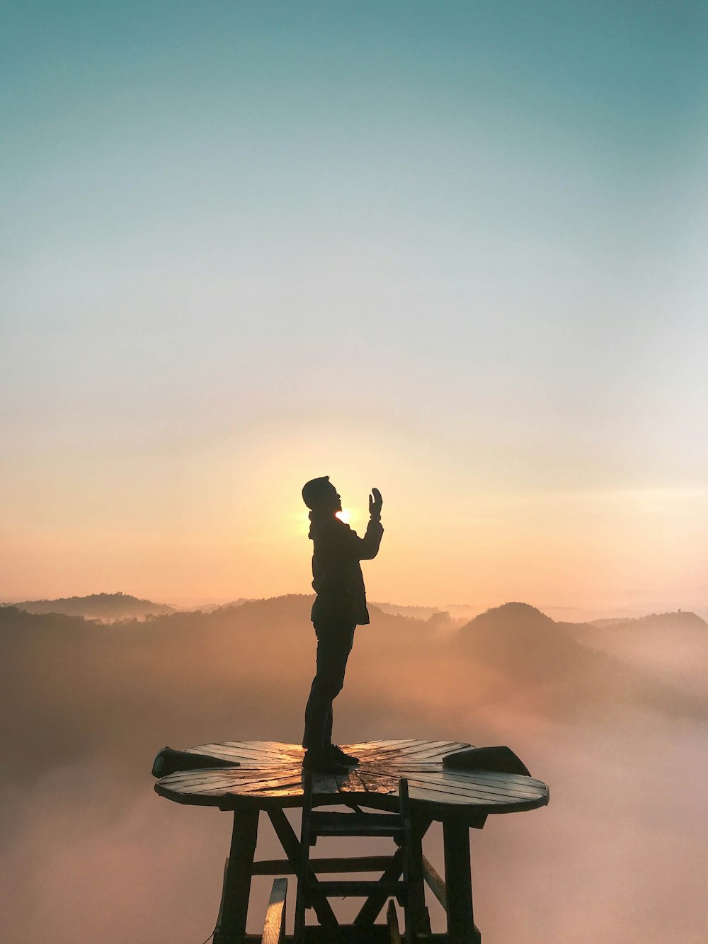 silhouette of praying man