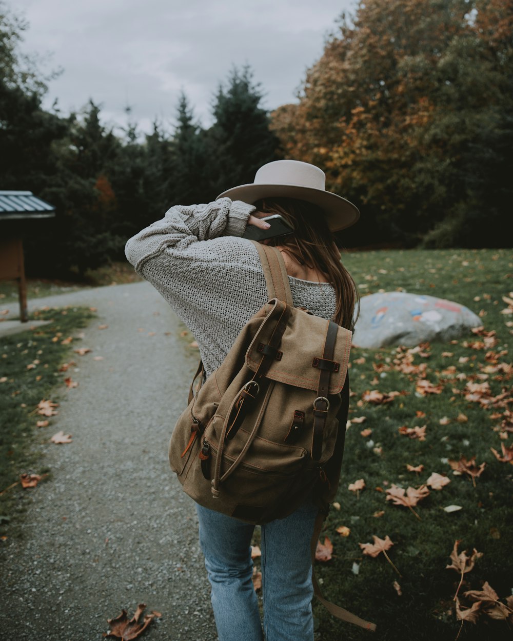 woman wears brown backpack