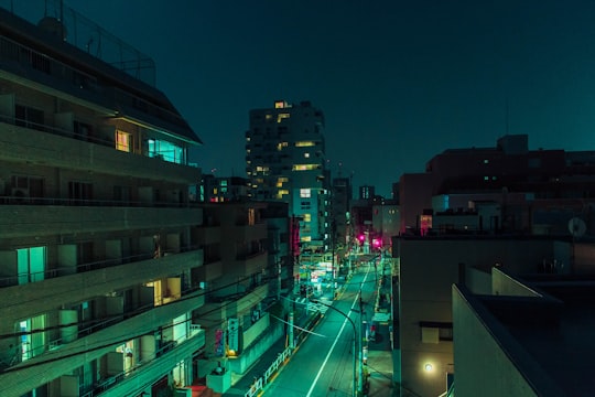 aerial photography of road between buildings at night in Harajuku Japan