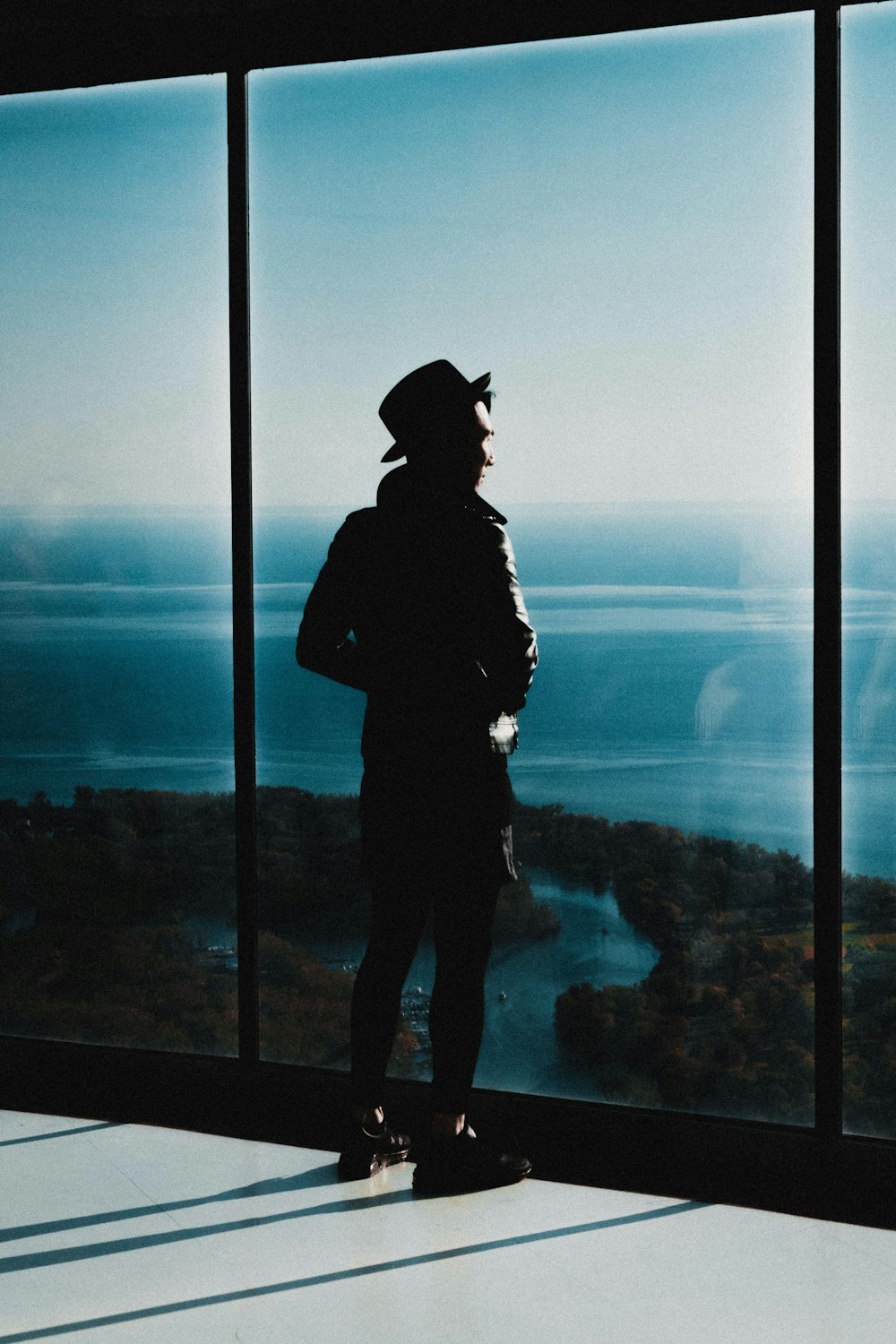 man standing beside window