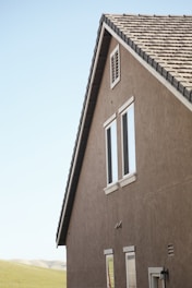 Before-and-after images of home exterior remodeling showcasing siding and stucco transformations.