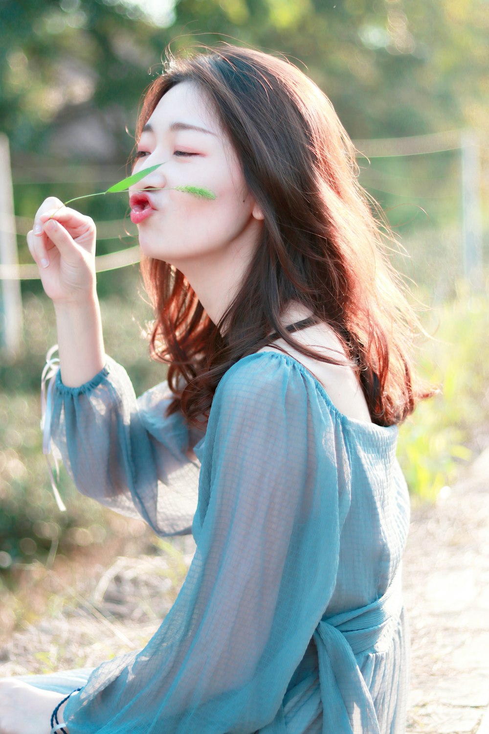 woman smelling leaf