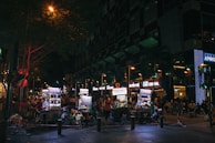 Evening street scene with glowing lanterns and food carts lined up for hungry crowds.