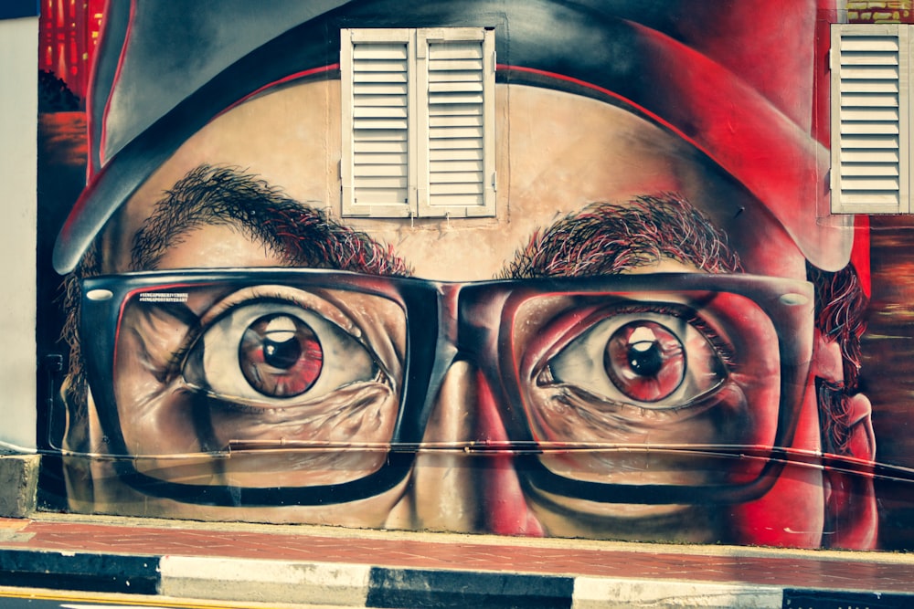 man wearing eyeglasses painting