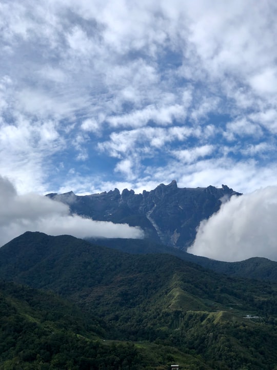green mountain under white clouds in Kundasang Malaysia