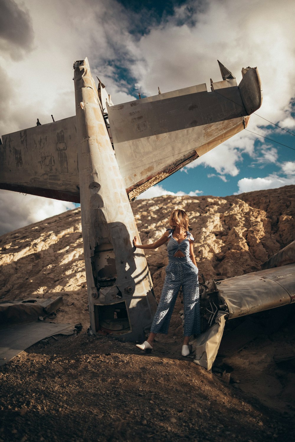 woman standing beside plane during daytime