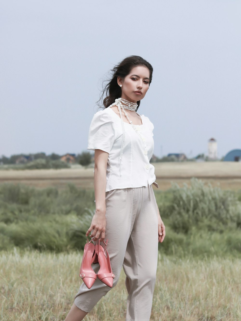 woman walking and holding sandals