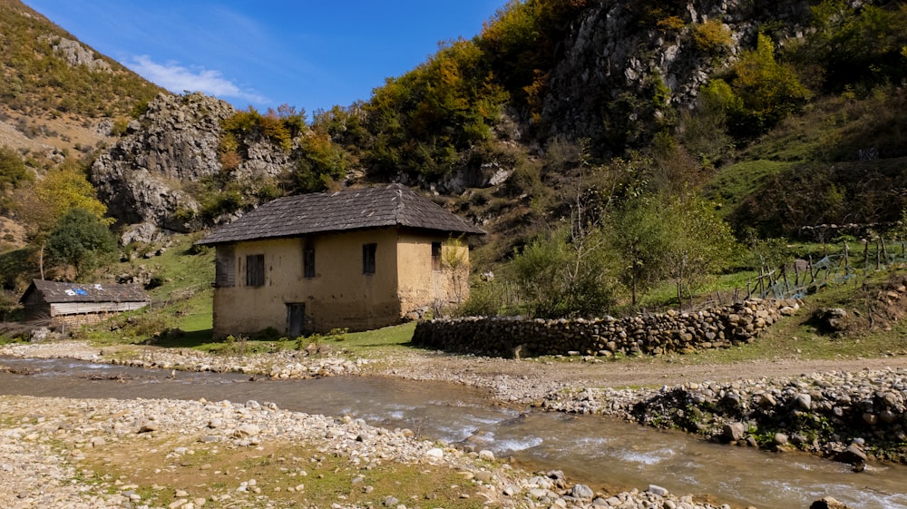 gray concrete house beside body of water