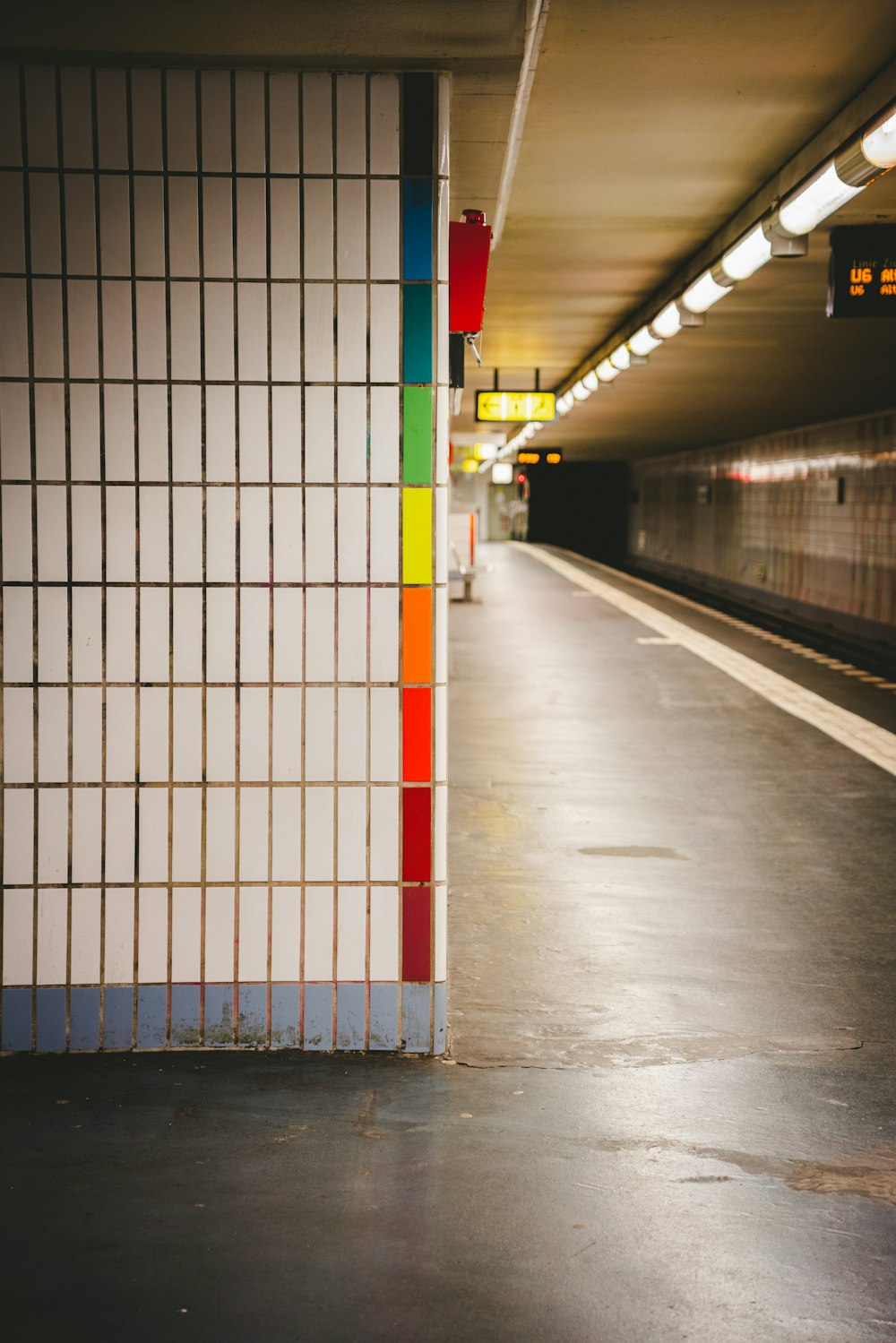 a subway station with a colorful wall next to it