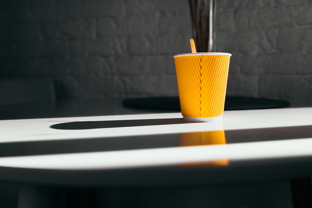 yellow cup on white surface
