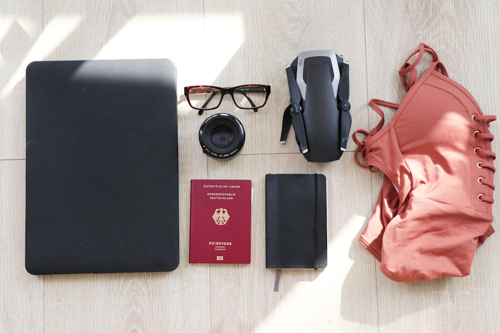 laptop, eyeglasses, passport, notebook, drone and swimsuit