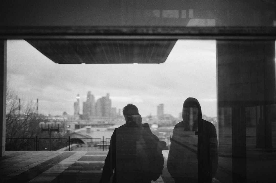 silhouette of two people on glass