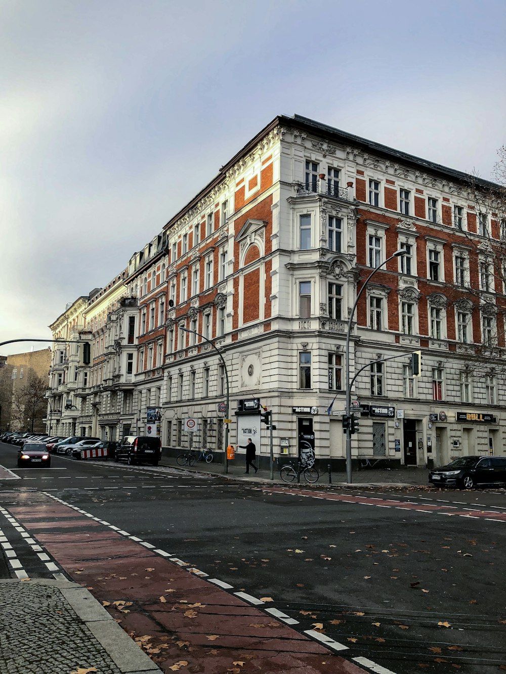 vehicles park near white building near the road