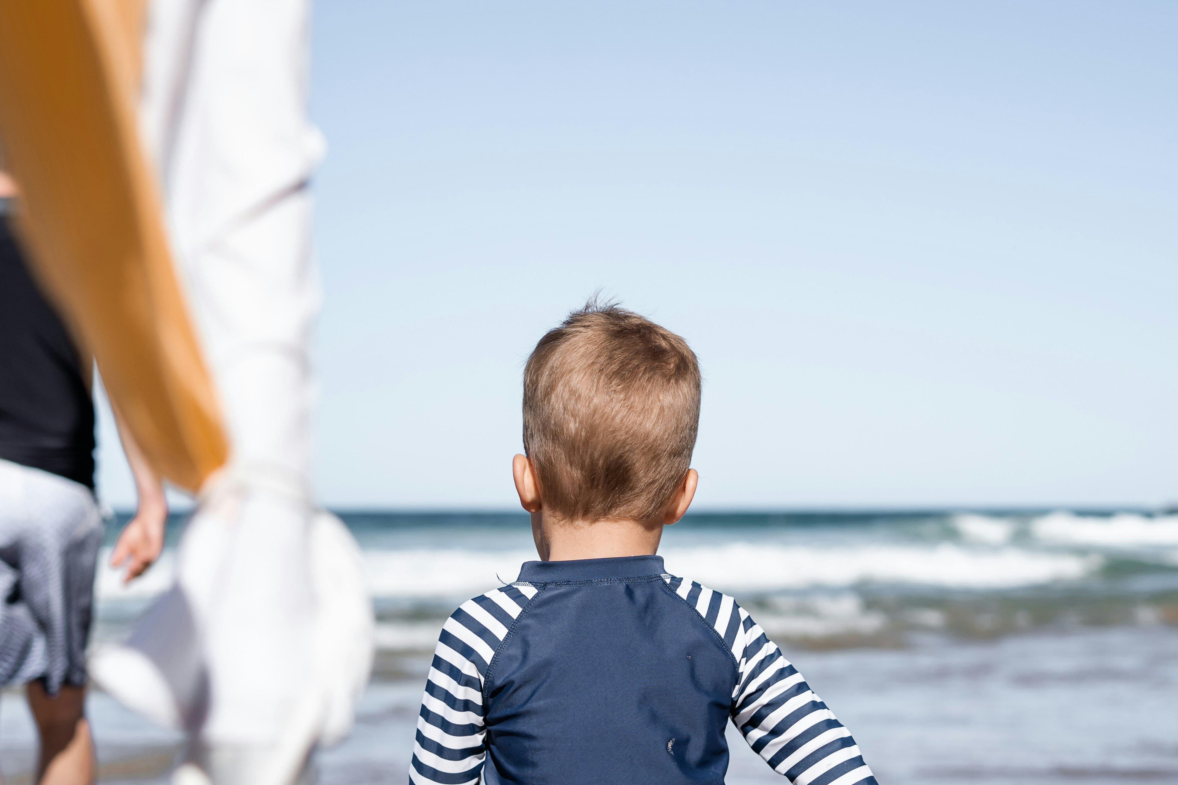 boy standing near ocean