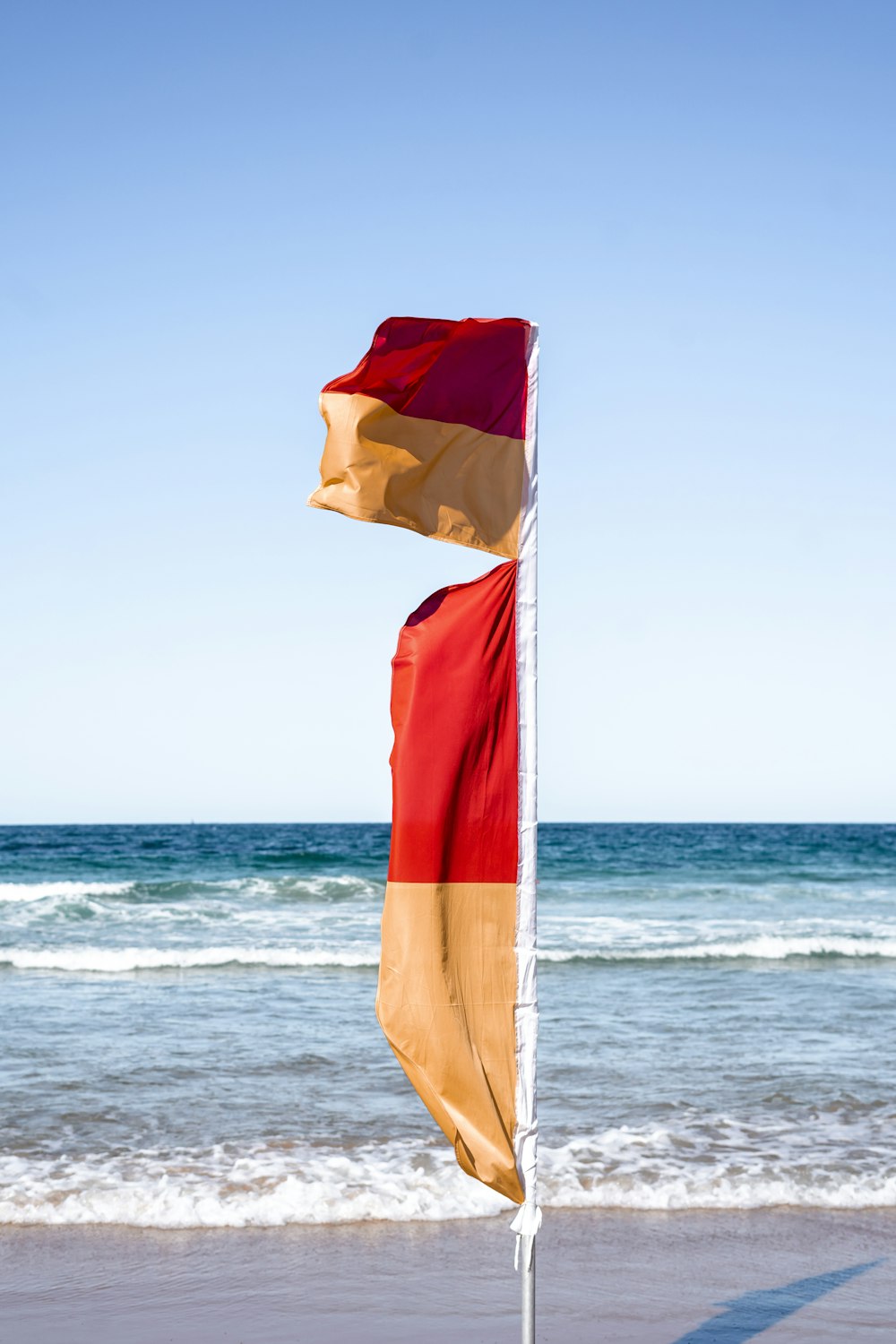 orange and red flaglets on shore