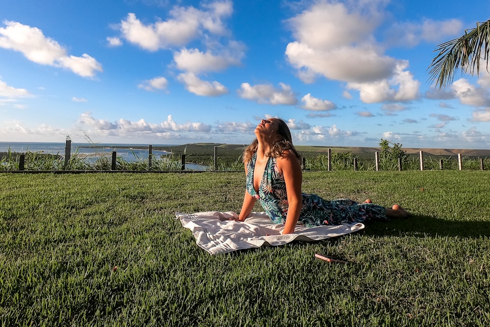 woman in green sleeveless dress doing yoga outdoor during daytime