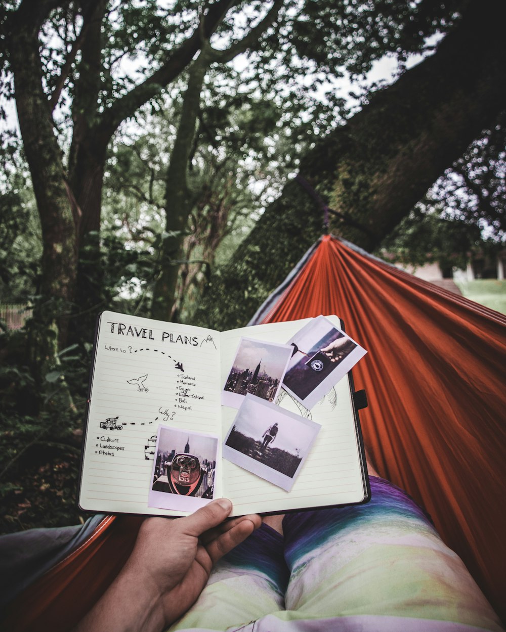 person in the hammock looking on travel plans