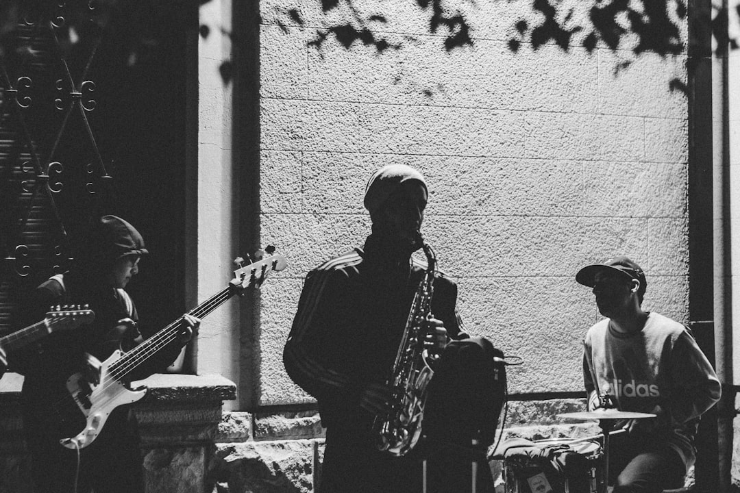 grayscale photo of person playing music instruments