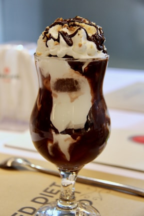 Decadent chocolate fudge sundae drizzled with caramel and topped with a cherry.