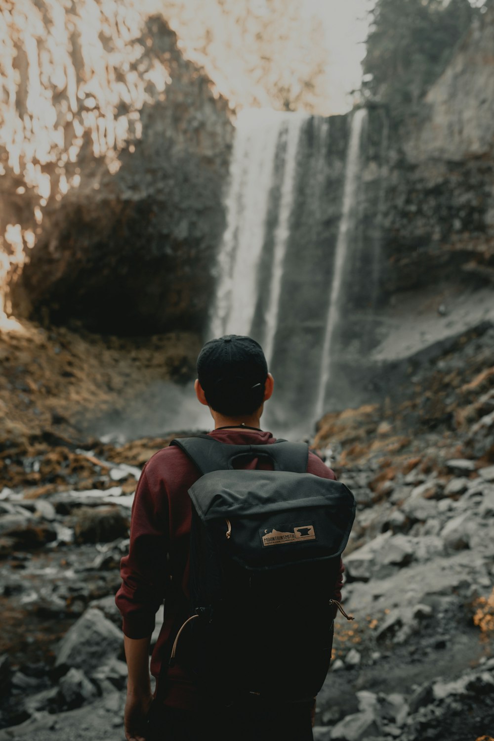 man near waterfall