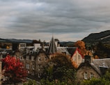 A scenic view of a historic European landmark framed by autumn trees.