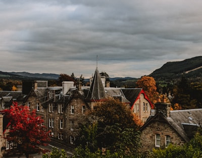 A scenic view of a historic European landmark framed by autumn trees.