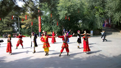 Traditional cultural dancers performing in vibrant costumes outdoors.